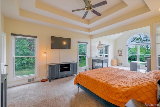 12462 Lillie Rd, Byron, MI 48418 - carpeted bedroom featuring multiple windows and a tray ceiling