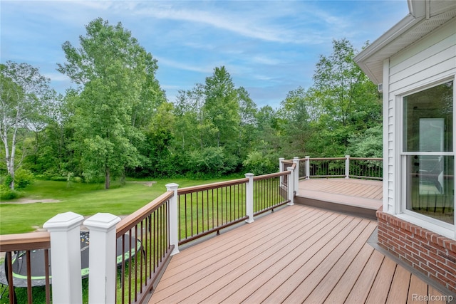 12462 Lillie Rd, Byron, MI 48418 - wooden deck with a lawn and view of wooded area