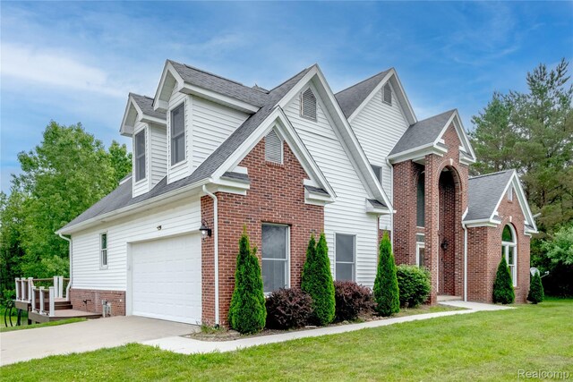 12462 Lillie Rd, Byron, MI 48418 - traditional-style home featuring brick siding, driveway, a front yard, a garage, and roof with shingles