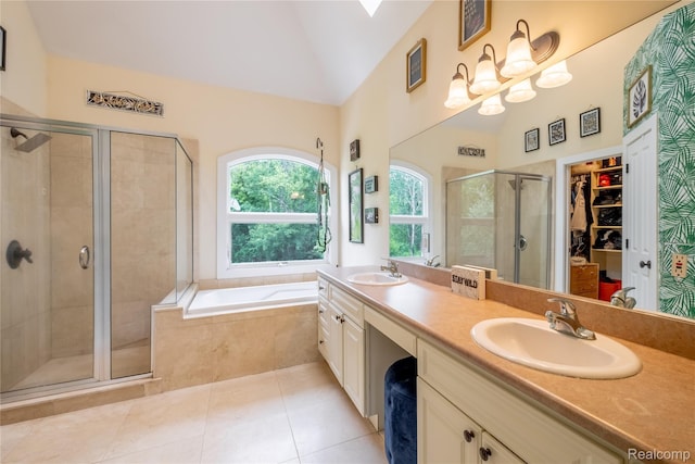 12462 Lillie Rd, Byron, MI 48418 - bathroom with a stall shower, double vanity, a spacious closet, a bath, and tile patterned floors