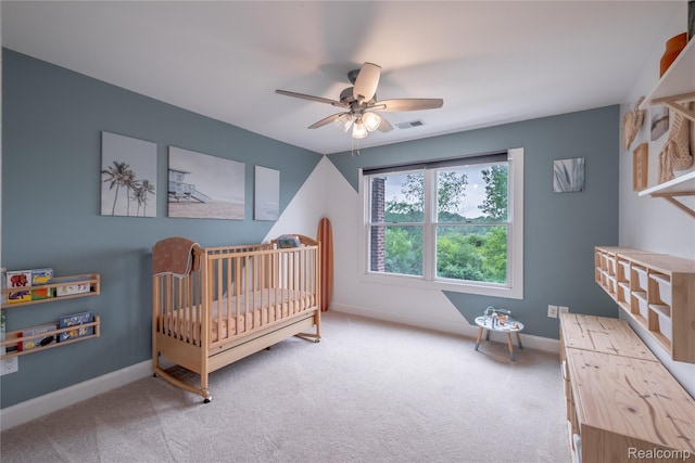 12462 Lillie Rd, Byron, MI 48418 - carpeted bedroom with a nursery area and a ceiling fan