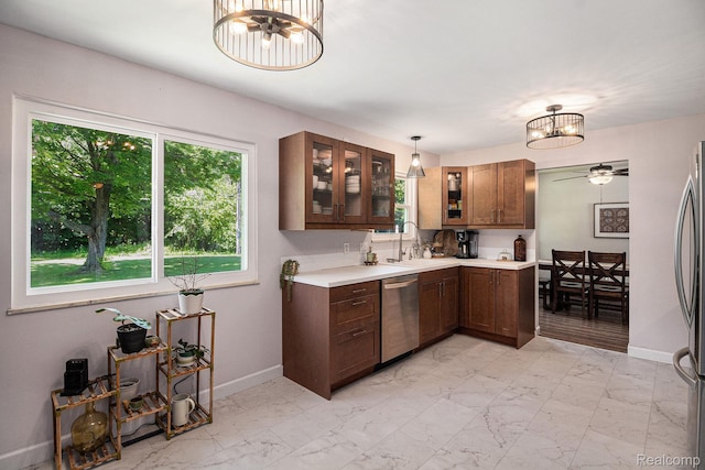 7440 Grandwood Dr, Swartz Creek, MI 48473 - kitchen with stainless steel appliances, a chandelier, light countertops, and light marble finish flooring