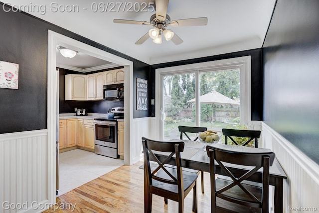 2861 Sunnyknoll Ave, Berkley, MI 48072 - dining area featuring a wainscoted wall, ceiling fan, a decorative wall, and light wood-style floors
