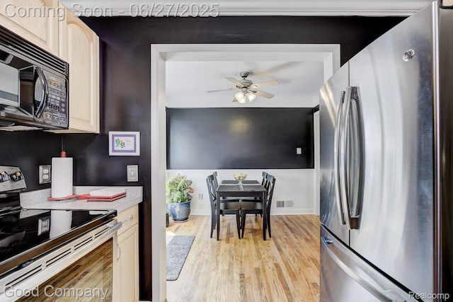 2861 Sunnyknoll Ave, Berkley, MI 48072 - kitchen featuring stainless steel appliances, a ceiling fan, light wood-type flooring, a wainscoted wall, and light countertops