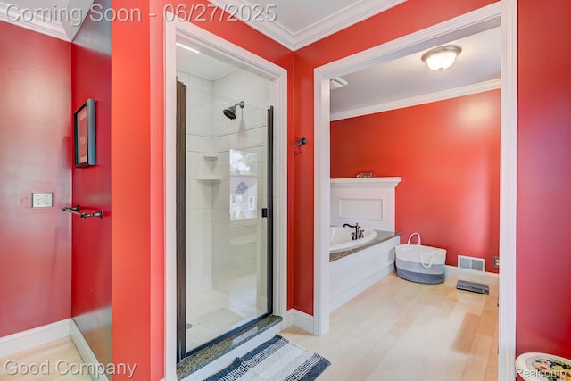 2861 Sunnyknoll Ave, Berkley, MI 48072 - full bath featuring a bath, a shower stall, ornamental molding, and wood finished floors
