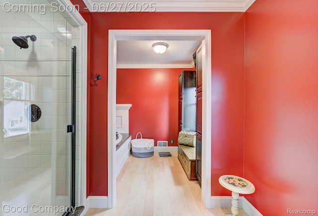 2861 Sunnyknoll Ave, Berkley, MI 48072 - bathroom with crown molding, a stall shower, wood finished floors, and ensuite bathroom