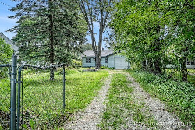1124 Kusterer Dr NW, Grand Rapids, MI 49534 - view of yard featuring dirt driveway and a gate