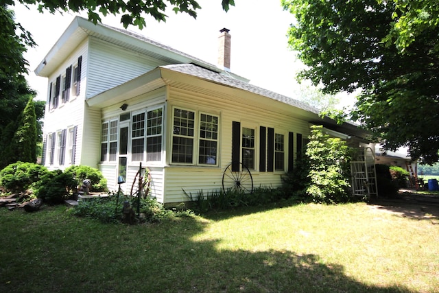 14585 E V Ave, Fulton, MI 49052 - view of side of home with a yard and a chimney