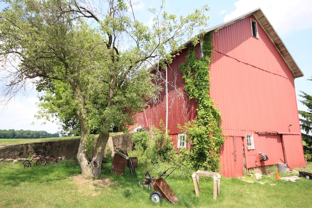 14585 E V Ave, Fulton, MI 49052 - view of home's exterior featuring a barn, an outbuilding, and a lawn