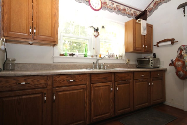 14585 E V Ave, Fulton, MI 49052 - kitchen with light countertops, brown cabinets, and dark wood finished floors