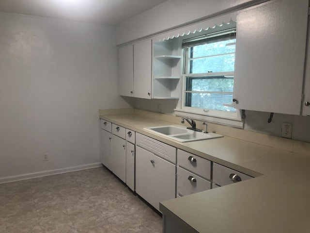 933 Westfall Ave, Kalamazoo, MI 49006 - kitchen with open shelves, light countertops, and white cabinets