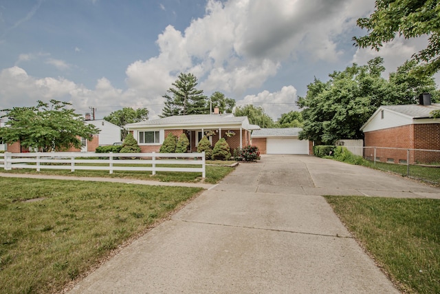1361 Holmes Rd, Ypsilanti, MI 48198 - view of front facade featuring brick siding and a detached garage