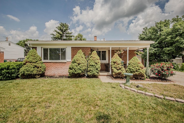 1361 Holmes Rd, Ypsilanti, MI 48198 - view of front facade with brick siding, a front yard, and covered porch