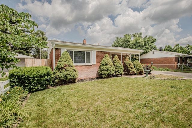 1361 Holmes Rd, Ypsilanti, MI 48198 - ranch-style home featuring brick siding and a chimney