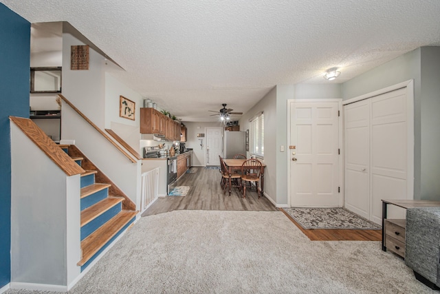 1361 Holmes Rd, Ypsilanti, MI 48198 - entryway with a textured ceiling, wood finished floors, a ceiling fan, and stairway