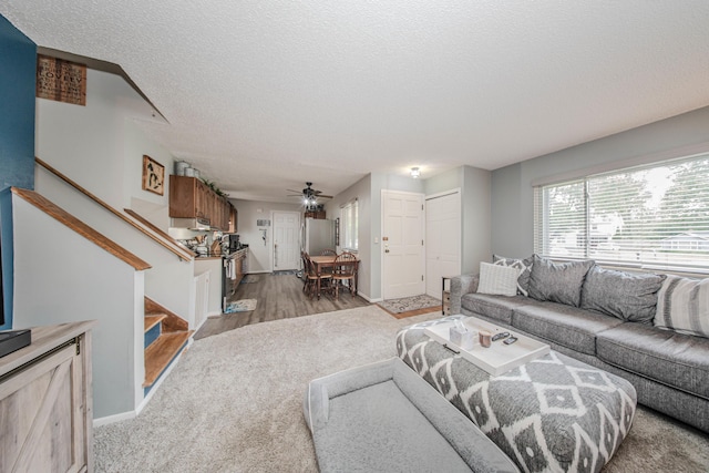 1361 Holmes Rd, Ypsilanti, MI 48198 - living area featuring stairs, a textured ceiling, ceiling fan, and light wood finished floors