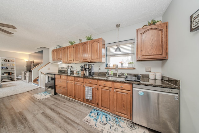 1361 Holmes Rd, Ypsilanti, MI 48198 - kitchen featuring stainless steel appliances, light wood-type flooring, a textured ceiling, under cabinet range hood, and ceiling fan