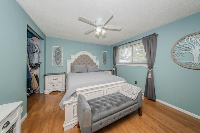 1361 Holmes Rd, Ypsilanti, MI 48198 - bedroom with light wood-style floors, a textured ceiling, a closet, and ceiling fan