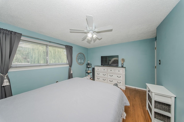 1361 Holmes Rd, Ypsilanti, MI 48198 - bedroom with wood finished floors, a textured ceiling, and a ceiling fan