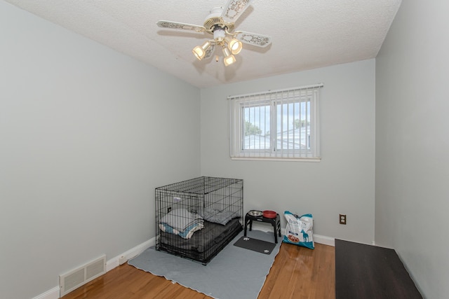 1361 Holmes Rd, Ypsilanti, MI 48198 - unfurnished bedroom featuring wood finished floors, ceiling fan, and a textured ceiling