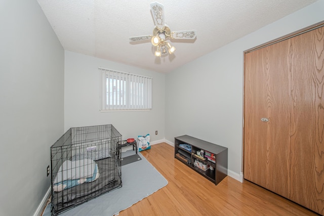 1361 Holmes Rd, Ypsilanti, MI 48198 - bedroom with light wood-style flooring, a ceiling fan, and a textured ceiling