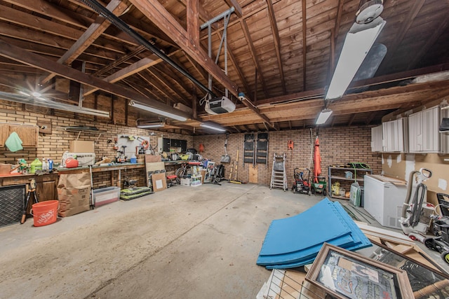 1361 Holmes Rd, Ypsilanti, MI 48198 - garage featuring a garage door opener and a workshop area