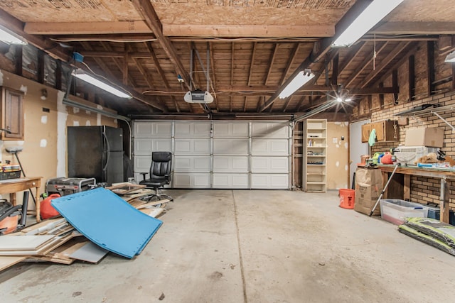 1361 Holmes Rd, Ypsilanti, MI 48198 - garage with a garage door opener and freestanding refrigerator