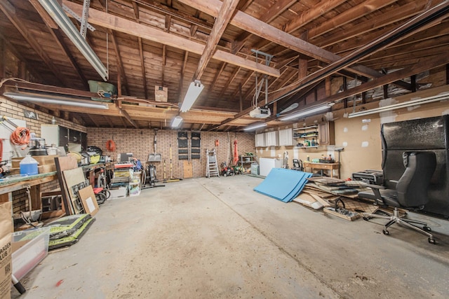 1361 Holmes Rd, Ypsilanti, MI 48198 - garage featuring a workshop area and freestanding refrigerator