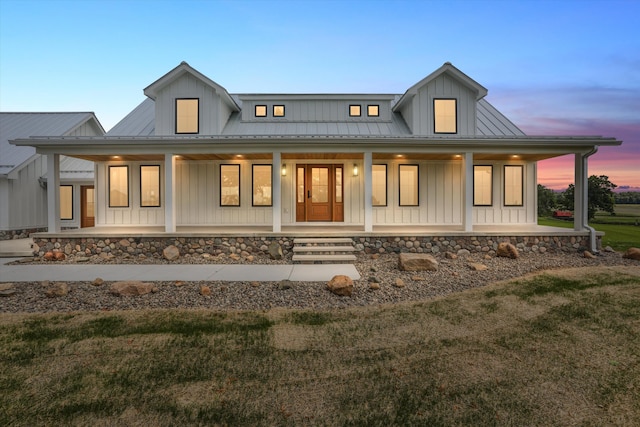 7280 Austin Rd, Saline, MI 48176 - modern farmhouse featuring board and batten siding, covered porch, a yard, and a metal roof