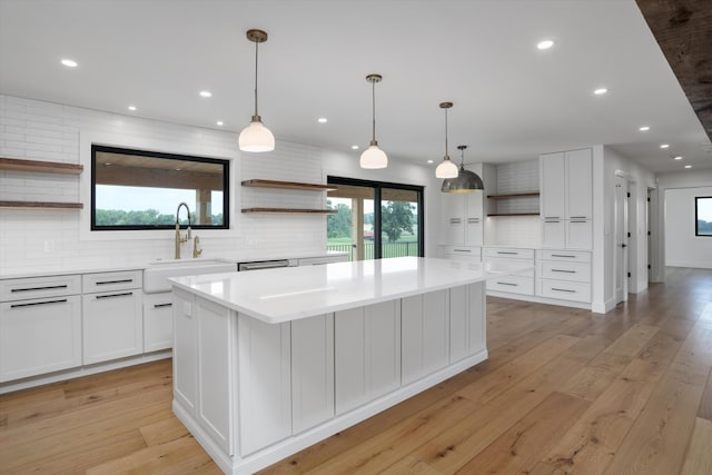 7280 Austin Rd, Saline, MI 48176 - kitchen featuring open shelves, decorative backsplash, a center island, light countertops, and white cabinetry