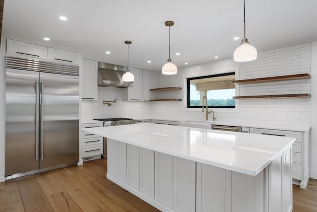7280 Austin Rd, Saline, MI 48176 - kitchen featuring high end appliances, open shelves, wall chimney range hood, backsplash, and light countertops