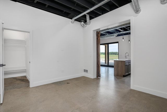 7280 Austin Rd, Saline, MI 48176 - empty room featuring finished concrete floors and baseboards