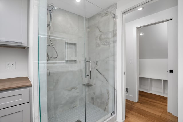 7280 Austin Rd, Saline, MI 48176 - bathroom with a stall shower, wood finished floors, and recessed lighting