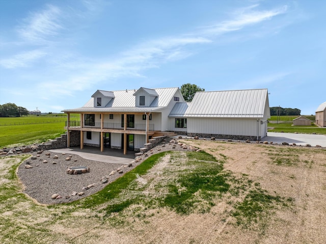 7280 Austin Rd, Saline, MI 48176 - view of front of home with a metal roof, covered porch, and a patio area