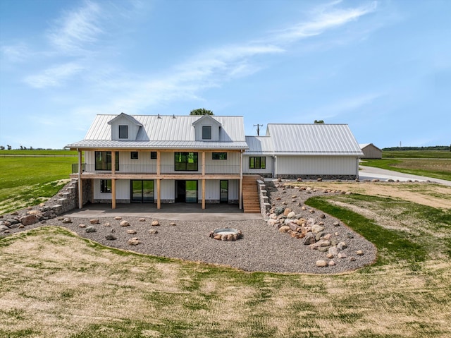 7280 Austin Rd, Saline, MI 48176 - view of front of property with a metal roof, a patio, a front yard, and a standing seam roof