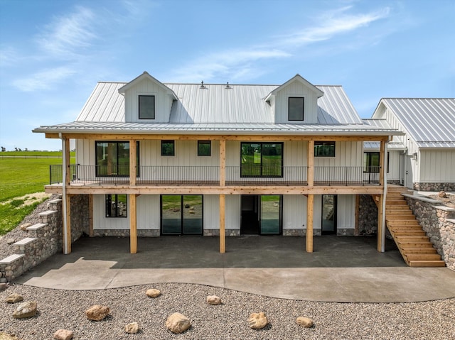 7280 Austin Rd, Saline, MI 48176 - back of property featuring a metal roof, board and batten siding, stairway, and a patio