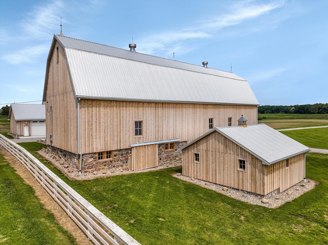 7280 Austin Rd, Saline, MI 48176 - view of home's exterior featuring an outdoor structure, a metal roof, a garage, and an outbuilding