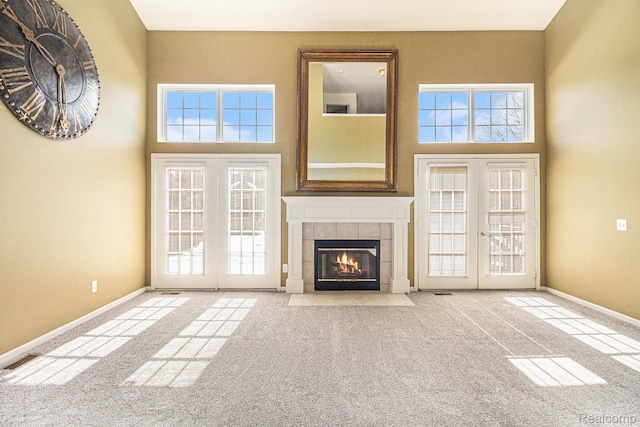 6438 Club Ct W, Grand Blanc, MI 48439 - unfurnished living room featuring french doors, carpet flooring, a towering ceiling, and a fireplace