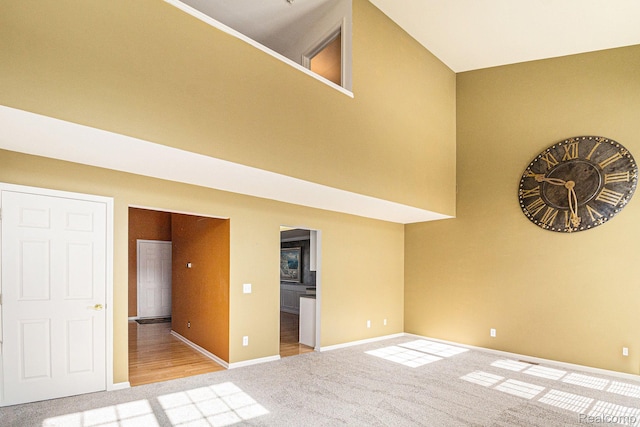 6438 Club Ct W, Grand Blanc, MI 48439 - carpeted empty room featuring baseboards and a high ceiling