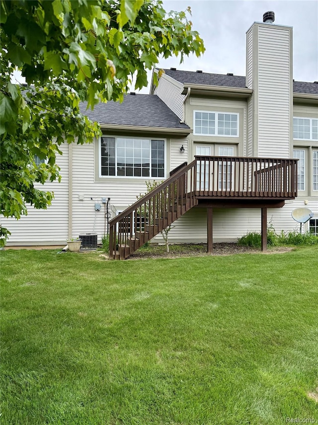 6438 Club Ct W, Grand Blanc, MI 48439 - back of property featuring a deck, a yard, stairway, a chimney, and a shingled roof