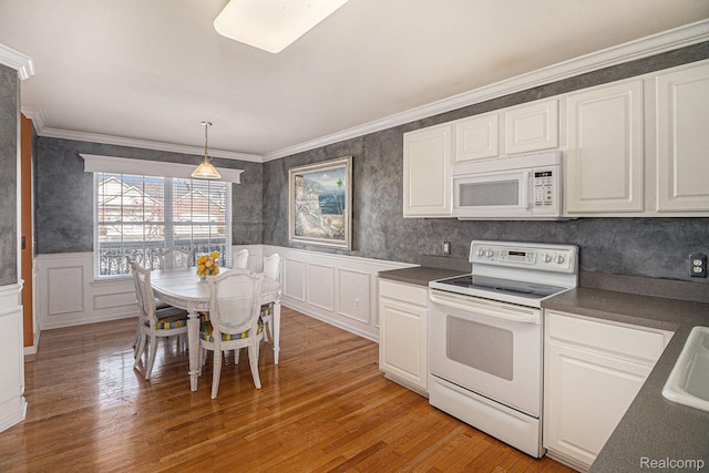 6438 Club Ct W, Grand Blanc, MI 48439 - kitchen featuring white appliances, dark countertops, light wood-style flooring, white cabinets, and a wainscoted wall