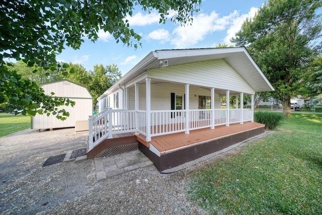 3280 Carlton Blvd, Jackson, MI 49203 - view of front facade featuring covered porch, a shed, and a front lawn