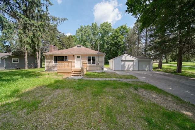 10620 Cady Rd, Jackson, MI 49201 - bungalow-style home with a garage, an outbuilding, a chimney, and a front yard