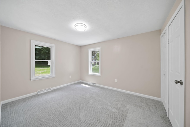 10620 Cady Rd, Jackson, MI 49201 - unfurnished bedroom featuring carpet flooring, a closet, and a textured ceiling
