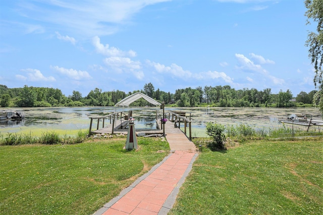 8828 Elm, Fremont, MI 49412 - dock area featuring a lawn, a water view, boat lift, and a wooded view