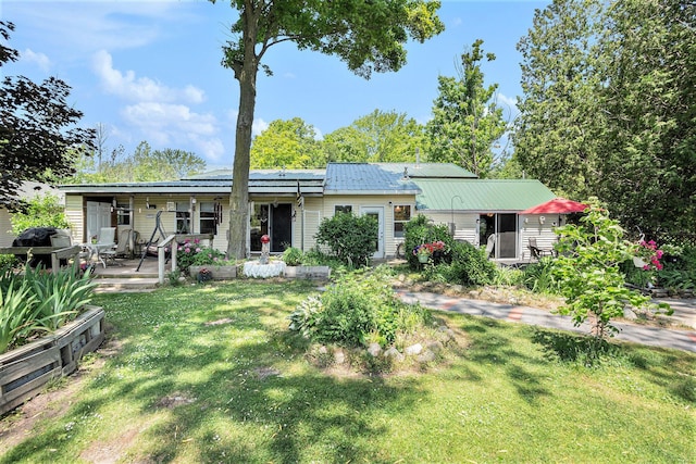 8828 Elm, Fremont, MI 49412 - back of house with a yard and a metal roof