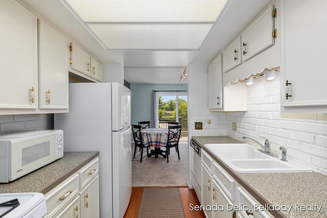 2623 Ridgecroft Dr SE Unit 301, Grand Rapids, MI 49546 - kitchen with white appliances, tasteful backsplash, light countertops, and white cabinetry