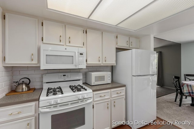 2623 Ridgecroft Dr SE Unit 301, Grand Rapids, MI 49546 - kitchen featuring white appliances, tasteful backsplash, and white cabinetry