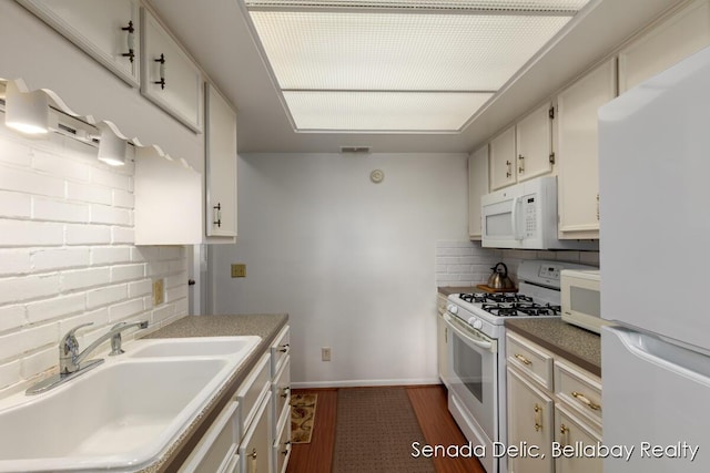 2623 Ridgecroft Dr SE Unit 301, Grand Rapids, MI 49546 - kitchen with white appliances, decorative backsplash, dark wood-style floors, and white cabinetry