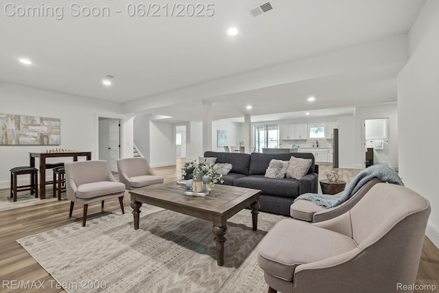 32575 Romsey Rd, Franklin, MI 48025 - living area with light wood-type flooring, recessed lighting, and stairway